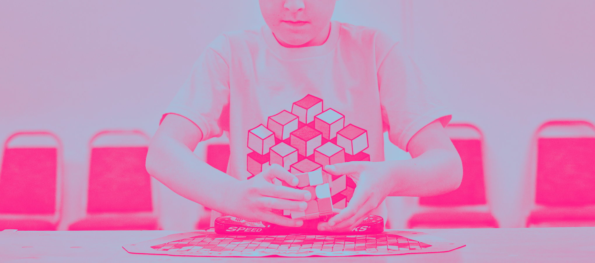 speedcubers at a cubing competition wearing geometric cubing puzzle design t-shirts from cubemunky