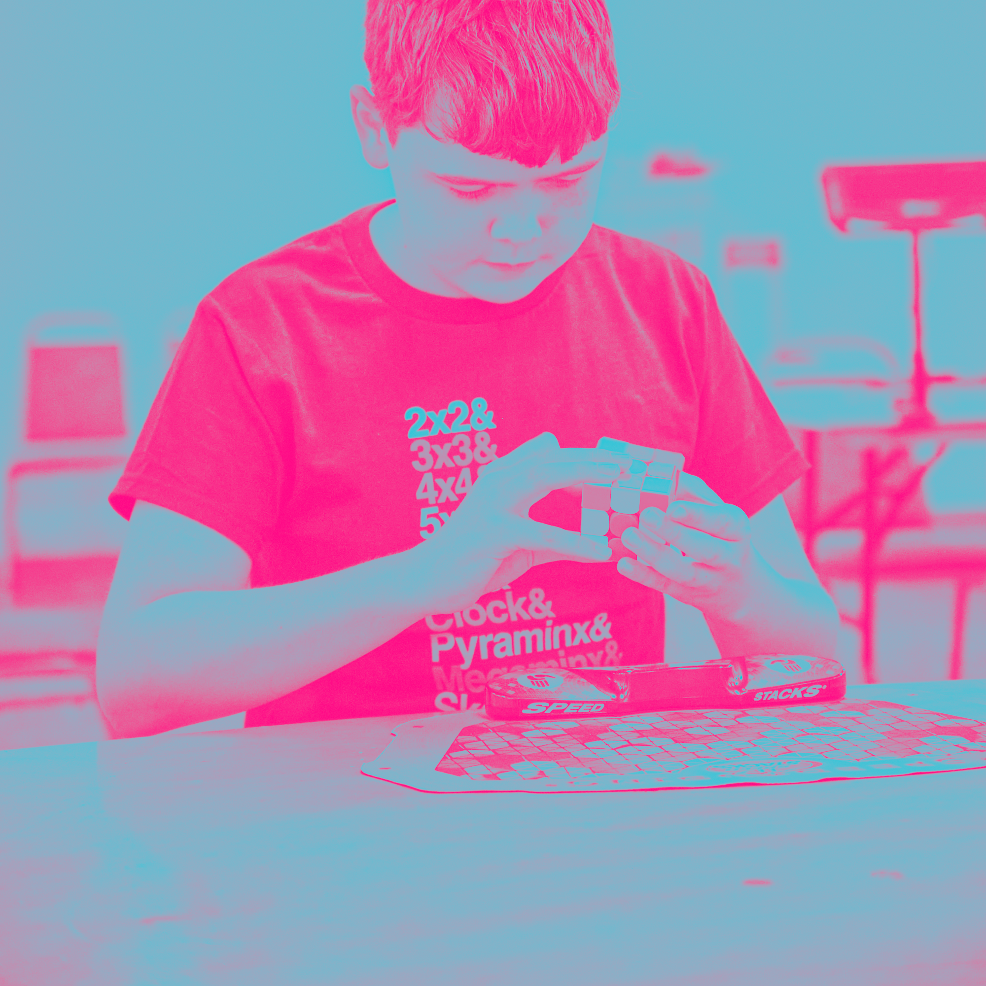 speedcubers at a cubing competition wearing geometric cubing puzzle design tshirts from cubemunky